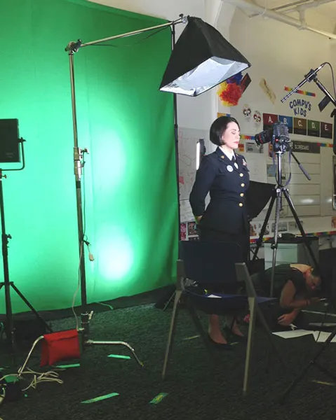 Behind the scenes: actor in naval uniform on a green screen set