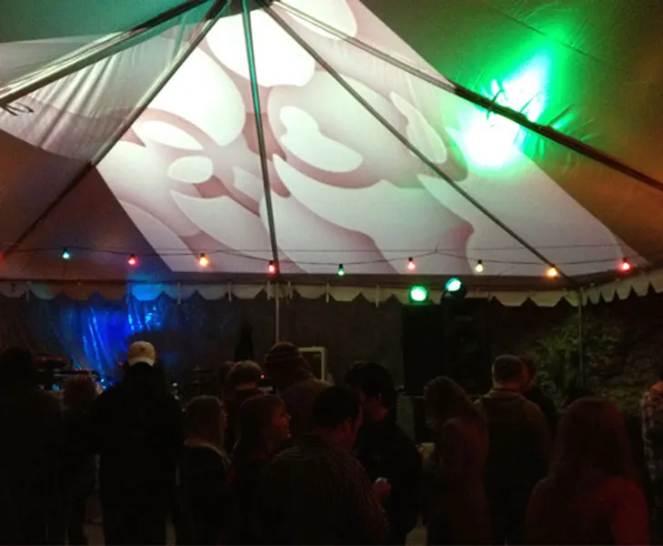 Qloo launch event crowd under a lit tent
